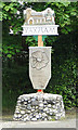 Yaxham village sign with centenary poppy