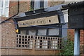 View of an old Valmar Cafe sign on Maple Road