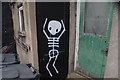 View of skeleton street art on the rear of Altered Images hairdressers from Evelina Road