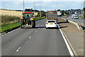 NO8991 : Tractor on the A92 by David Dixon