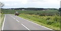 Farmer feeding cattle in field on the south side of the A25