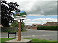 TF5209 : Marshland St. James village sign by Adrian S Pye