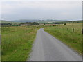 Fence-lined minor road between Howgate and The Kames