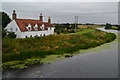 Isolated riverside house by the old bridge at Tattershall Bridge