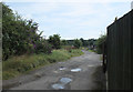 Rough road behind houses on Milton Road