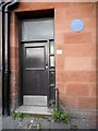 Door to a close with a blue plaque