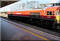 Class 66 diesel locomotive passing through Cardiff Central station