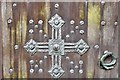 St. Germans Priory Church: Norman west doorway with seven weathered orders, door detail