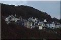 View of houses on The Parade at Mousehole from the coastal path at sunrise