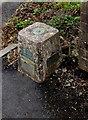 Corner view of an Ordnance Survey Bench Mark in Peniel, Carmarthenshire