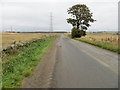 Road between harvested fields near to Netherton