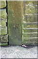 Benchmark on stone post in wall on SE side of Midgley Road