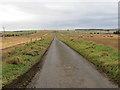 Minor road passing through arable land near Hindhillock