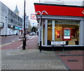 Bilingual street name sign on a town centre corner, Neath