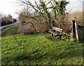 Bench at the edge of a green in Pantyffordd