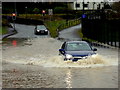 H4572 : Risking it through the flooded road, Campsie by Kenneth  Allen