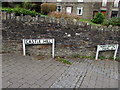 Castle Hill name sign alongside a stone wall, Gelligaer