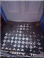 SH6266 : A debris covered tiled former shop doorway on the High Street, Bethesda by Meirion