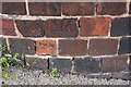 Benchmark on wall outside #2 Cromwell Road at Hawksley Avenue junction