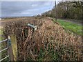 Public Footpath sign knocked over in the hedge