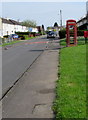 Pavement towards a red phonebox and postbox, Stonehouse