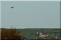 A helicopter flies over houses In Braunton