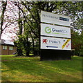 Three name signs on a bank above Llantarnam Park Way, Cwmbran