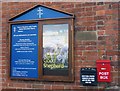 Noticeboard and post boxes on United Reformed Church