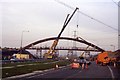 Installing the wooden footbridge over the A523 Silk Road