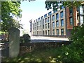 Gatepost of Allhallows churchyard, and student accommodation, Exeter