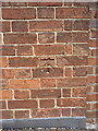 SJ7103 : OS benchmark - Sutton Wood, house on Brick Kiln Lane by Richard Law