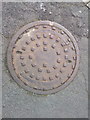 Large manhole cover on Maes Derw, Llandudno Junction