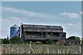 TM1867 : Kenton: Partially disused farm building and silo by Michael Garlick