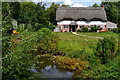 Thatched cottage beside the River Bourne