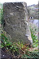 Benchmark on stone post at end of wall at Sun Lane road junction