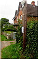 SO3711 : Neighbourhood Watch sign on a wooden pole, Llanarth by Jaggery