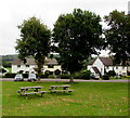 Picnic tables and trees on the village green, Llanddewi Rhydderch, Monmouthshire