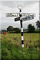 Signpost, letter box, noticeboard and fields at crossroads in North Dykes