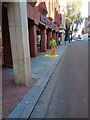 Stencilling a one way arrow for pedestrians, Exeter High Street