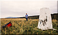 SD6753 : Trig point, hill walker and wall on Burn Fell by Trevor Littlewood