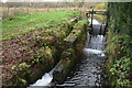 Sluice in former mill leat on the River Bourne