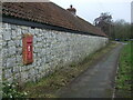 A long barn with a postbox