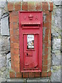 A Victorian postbox on a barn