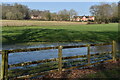 Waterlogged field with view of distant houses on Salisbury Road