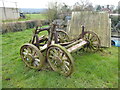 Ancient wagon wheels piled beside the path at Sundorne Farm