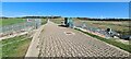 Path across River Rother flood control embankment