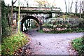 Railway viaduct over track at bend in minor road