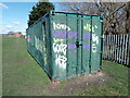 View of a shipping container covered in graffiti in Parsloes Park