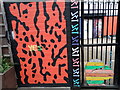 View of street art on the gates at the rear of Rich Mix on Redchurch Street