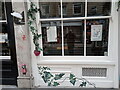 View of ivy street art alongside real ivy around the window of Lluka nail bar on Cheshire Street